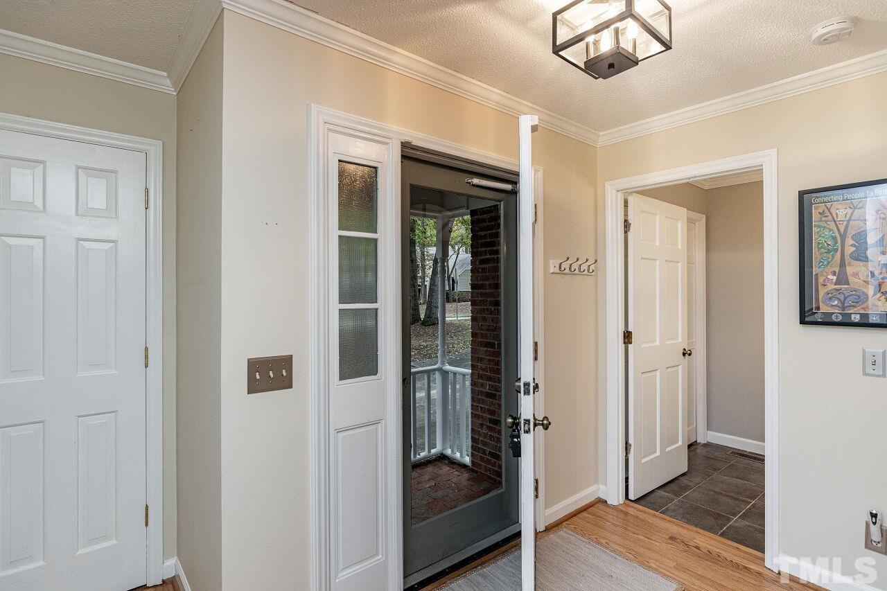7811 Breckon Way Raleigh, NC 27615 - Photo 6 of 30 wooden floor with windows and brick walls