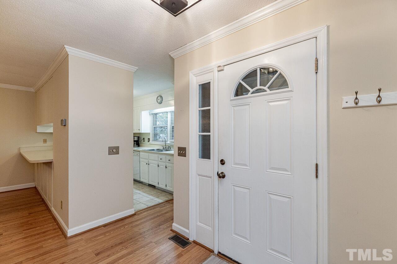 7811 Breckon Way Raleigh, NC 27615 - Photo 7 of 30 a view of a hallway with wooden floor and closet