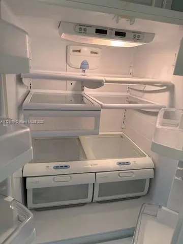 a bathroom with a granite countertop toilet sink and mirror