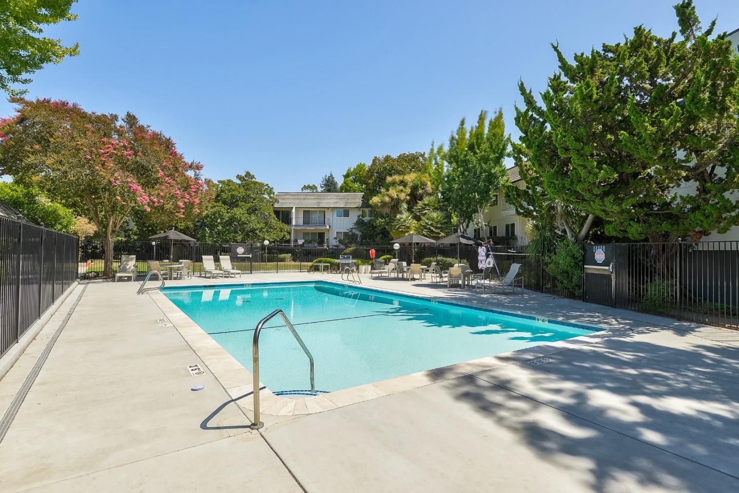21 Willow Road, Unit 24 Menlo Park, CA 94025 - Photo 20 of 22 a swimming pool with outdoor seating and yard