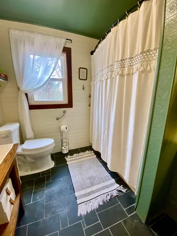 a bathroom with a toilet and shower