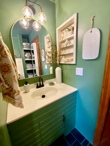a bathroom with a sink vanity and a mirror