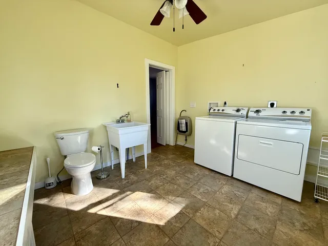 a room with a washing machine and a fireplace