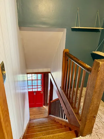 a view of staircase with open kitchen view