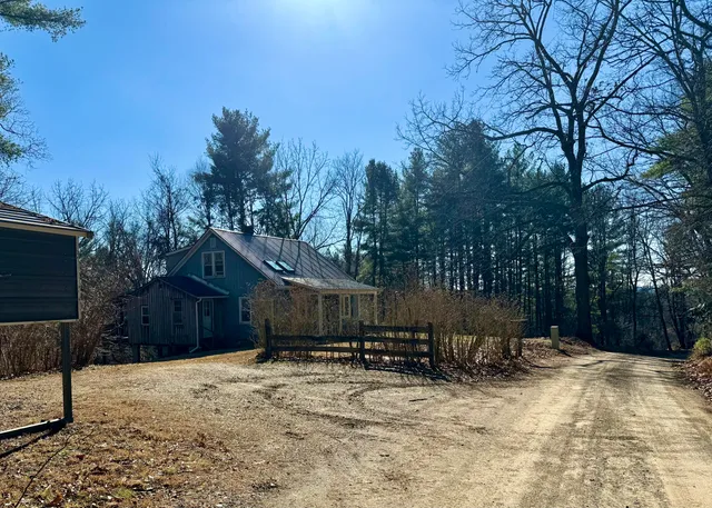 a view of a house with a yard covered in snow