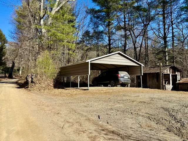 a front view of a house with a yard covered in snow