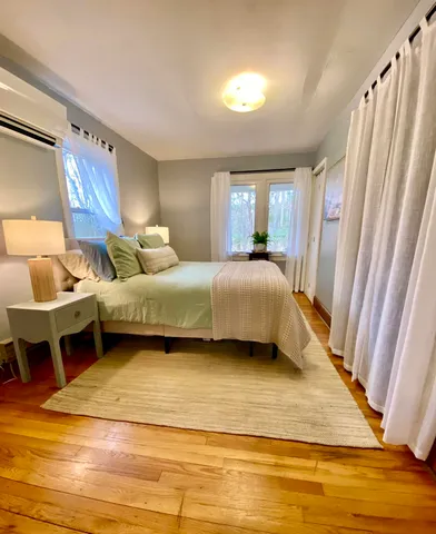 a living room with a bed furniture and a window