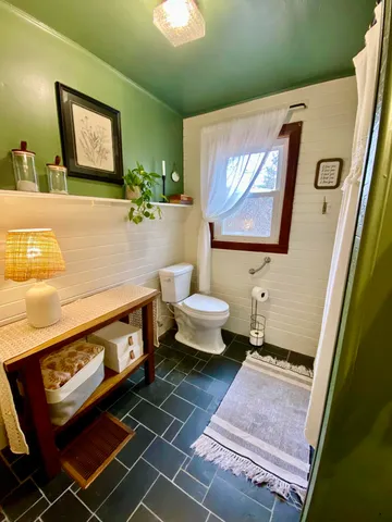 a bathroom with a sink mirror and toilet