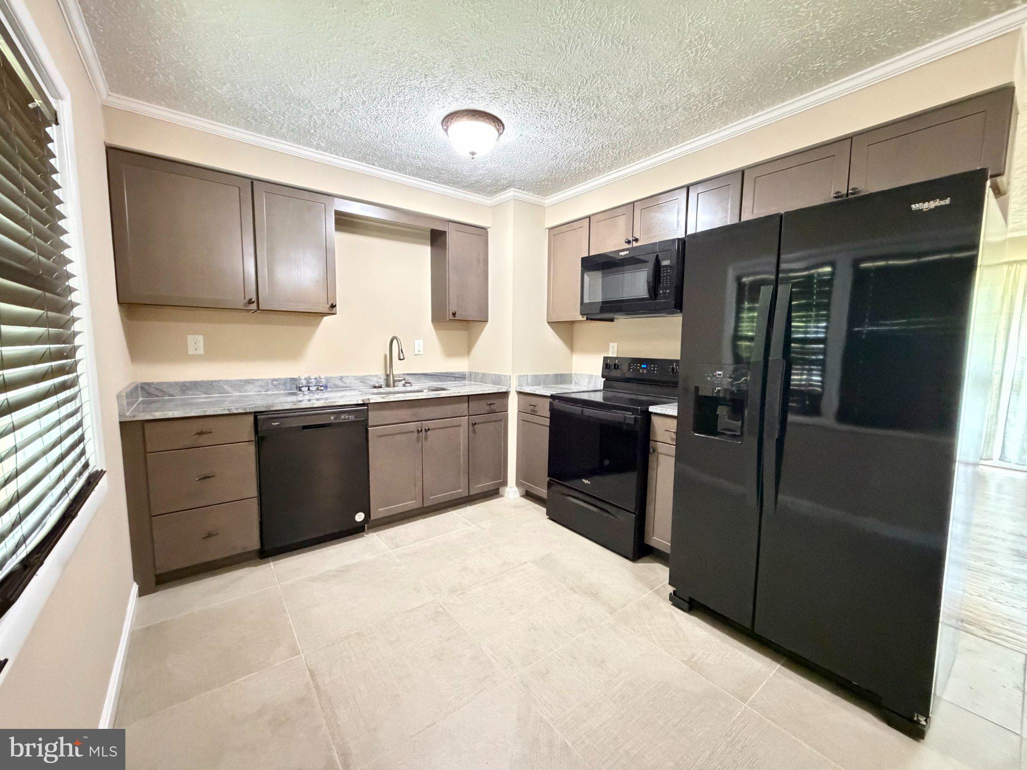 6109 Cracklingtown Road Hughesville, MD 20637 - Photo 14 of 25 a kitchen with stainless steel appliances granite countertop a refrigerator and a sink