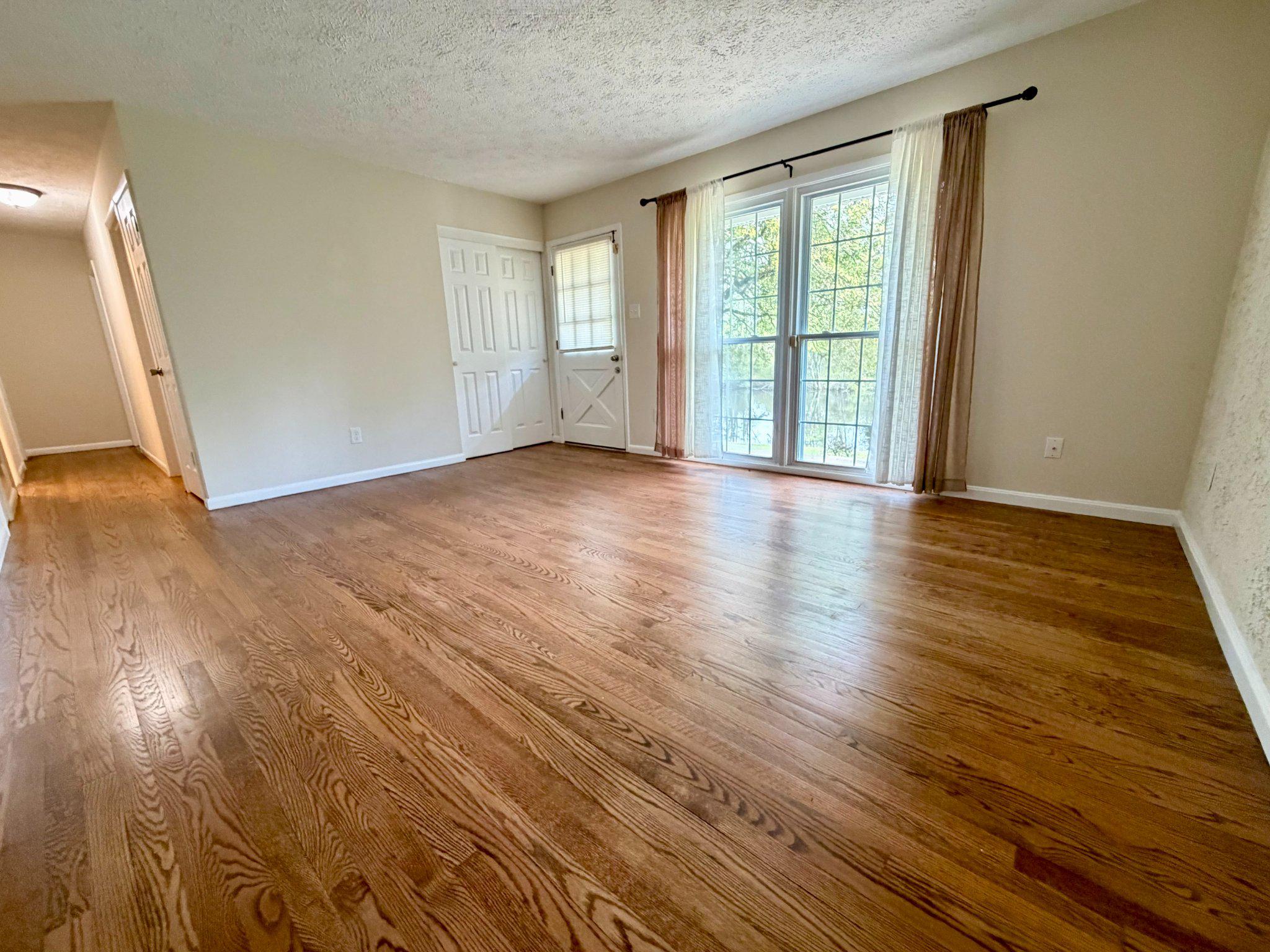 6109 Cracklingtown Road Hughesville, MD 20637 - Photo 15 of 25 a view of an empty room with wooden floor and a window
