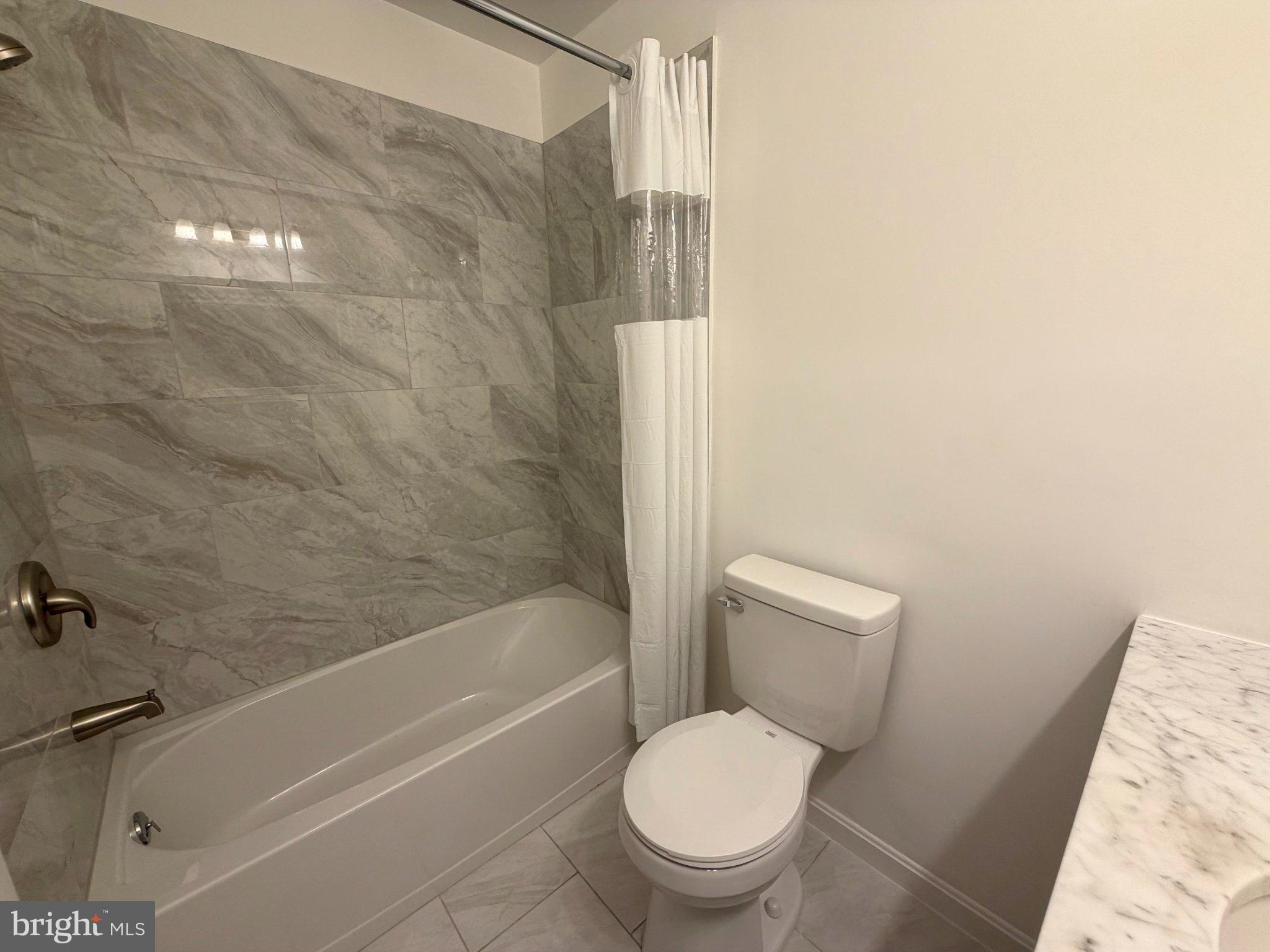 6109 Cracklingtown Road Hughesville, MD 20637 - Photo 19 of 25 a white toilet and tub sitting next to a bathroom sink
