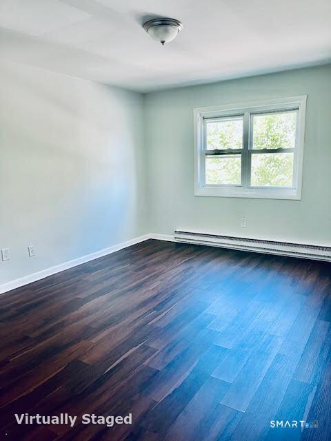 45 Monroe Street, Unit B8 Bridgeport, CT 06605 - Photo 4 of 14 an empty room with wooden floor and windows