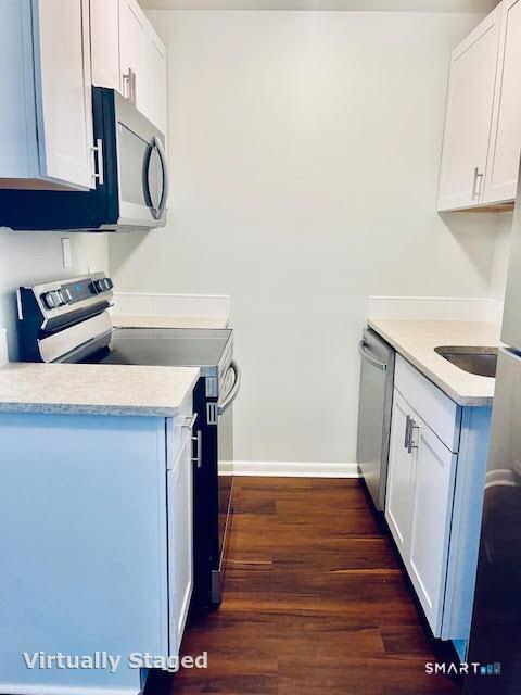 45 Monroe Street, Unit B8 Bridgeport, CT 06605 - Photo 9 of 14 a kitchen with a sink a stove and cabinets