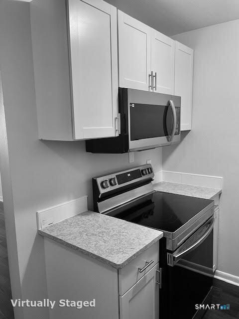 45 Monroe Street, Unit B8 Bridgeport, CT 06605 - Photo 10 of 14 a kitchen with granite countertop a stove and a microwave