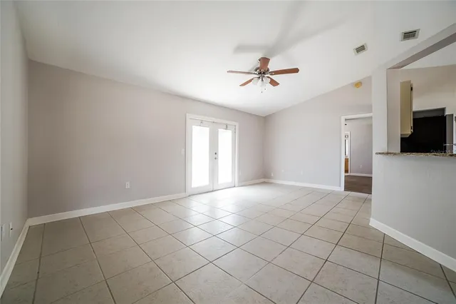 a view of an empty room with a fireplace and a window