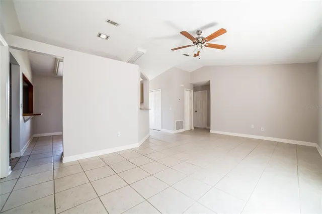 a view of a livingroom with a ceiling fan and window