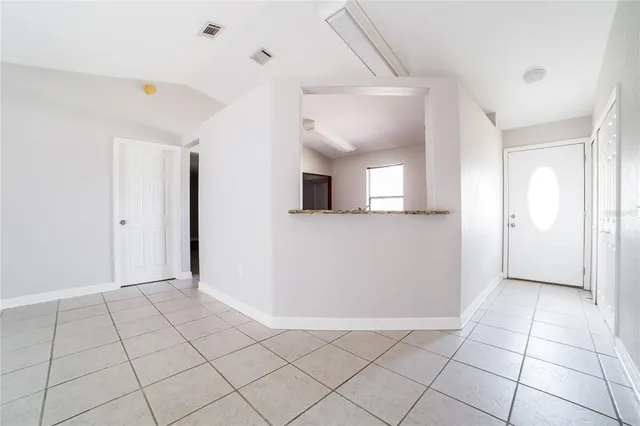 a view of a livingroom with an empty space and a window