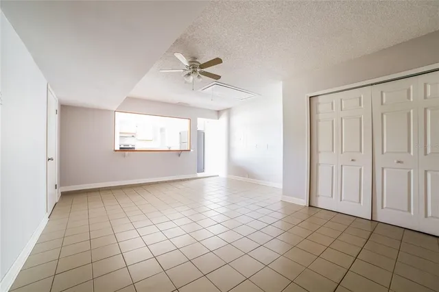 a view of an empty room and a window