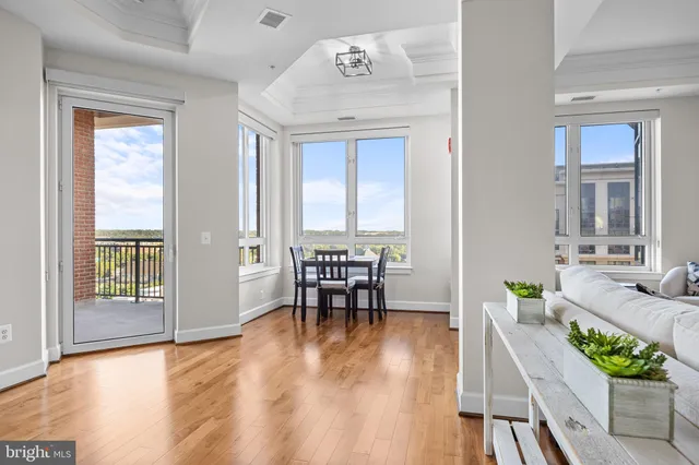 a view of a dining room with furniture and wooden floor