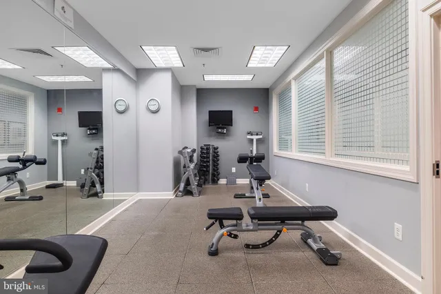 a kitchen with a sink a counter and chairs