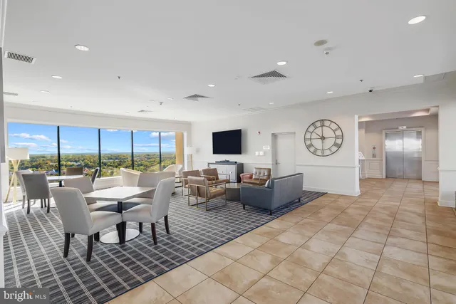 a view of a swimming pool with outdoor seating