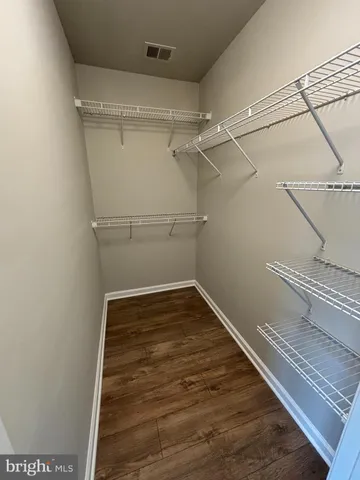 a bathroom with a granite countertop bathtub sink and mirror