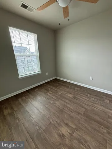 wooden floor in an empty room with a mirror