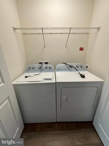 a view of a livingroom with wooden floor and staircase