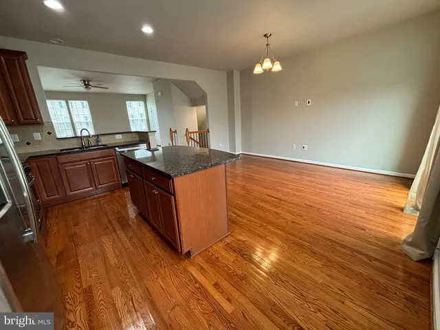 a kitchen with stainless steel appliances granite countertop a stove top oven a sink and dishwasher