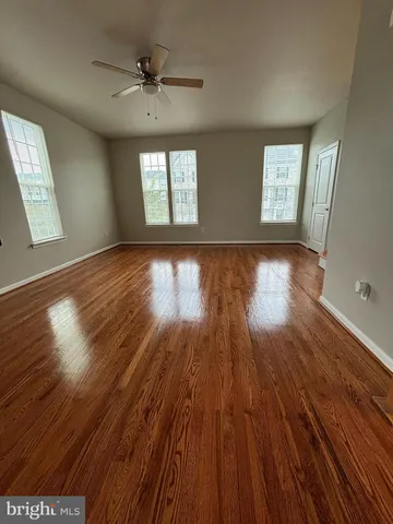 a view of a livingroom with a hardwood floor and a ceiling fan