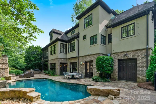 a front view of a house with swimming pool having outdoor seating