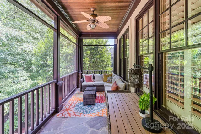 a view of a room with wooden floor and furniture