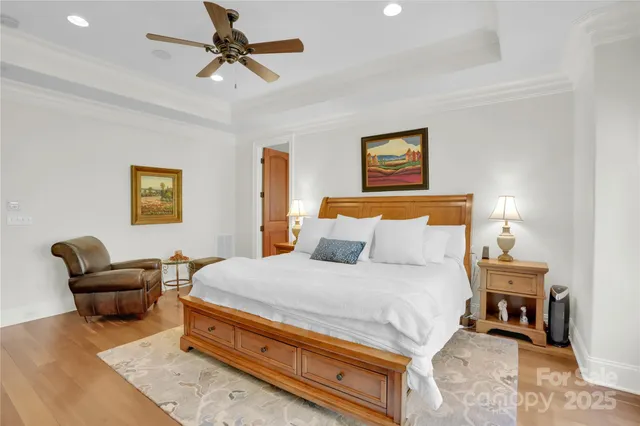 a view of a hallway with wooden floor and stairs
