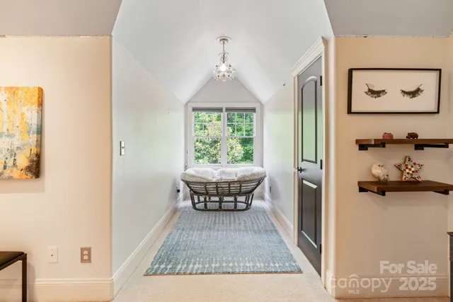 a view of backyard with a table and chairs couches with wooden fence and floor
