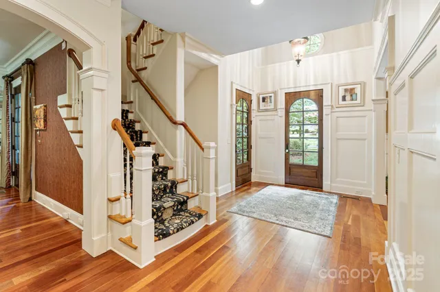 a living room with furniture a rug and a flat screen tv