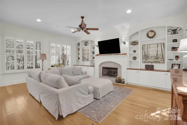 a dining hall with stainless steel appliances granite countertop a stove and a view of living room