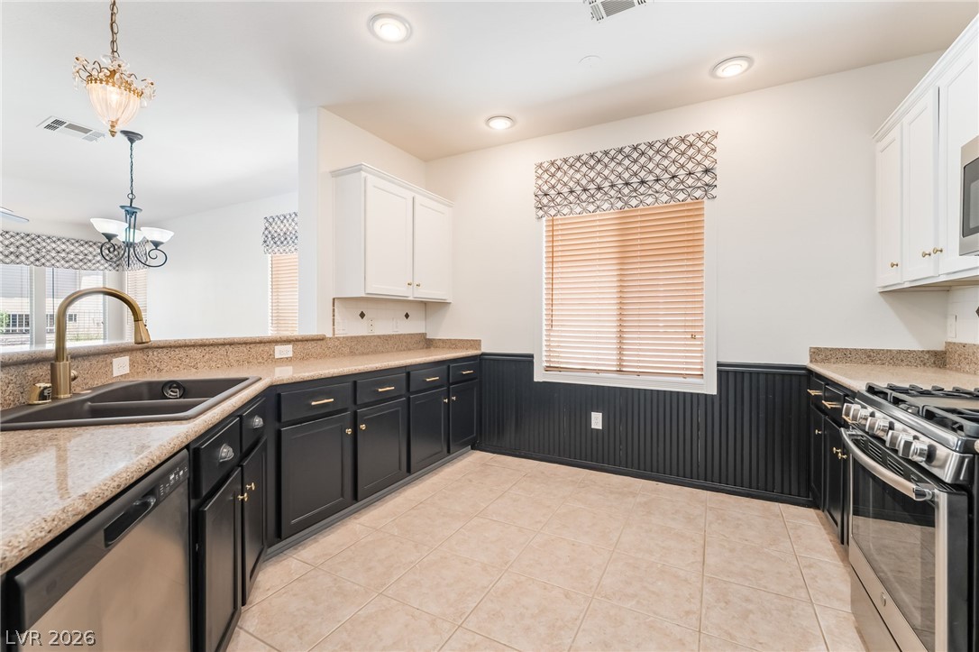 5389 Progresso Street Las Vegas, NV 89135 - Photo 12 of 41 A well-appointed kitchen features ample counter space, rich cabinetry, and a bright window.