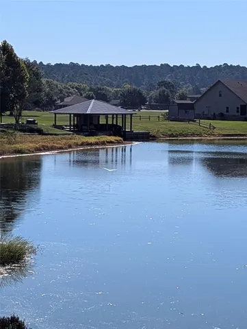 a view of house with outdoor space and lake view