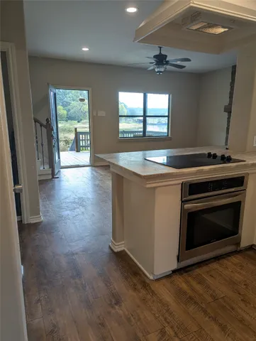 a view of an empty room with a fireplace and a window