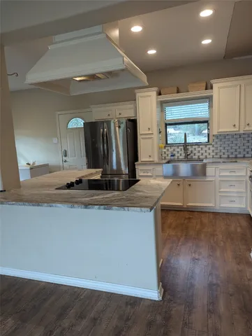 a view of a kitchen with a sink and a large window
