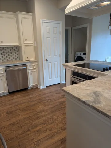 a kitchen with stainless steel appliances granite countertop a sink and a stove top oven