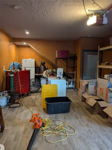 a living room with patio furniture and a wooden floor