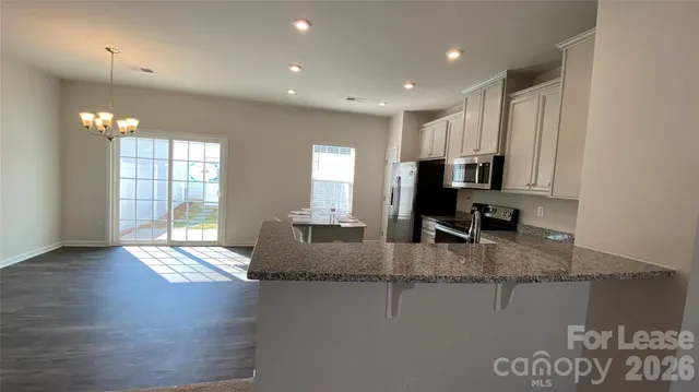 a kitchen with sink refrigerator and window