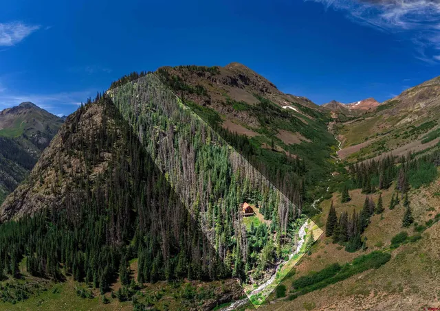 a view of a large building with a mountain in the background