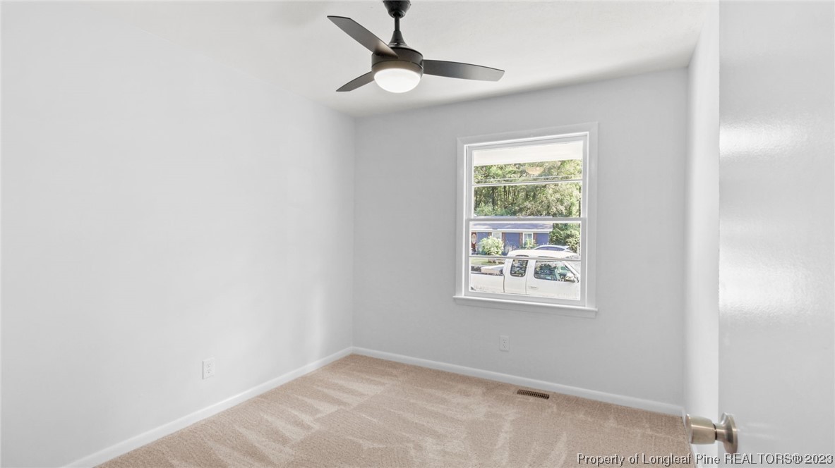 5867 Columbine Road Fayetteville, NC 28306 - Photo 17 of 26 a view of an empty room with a window