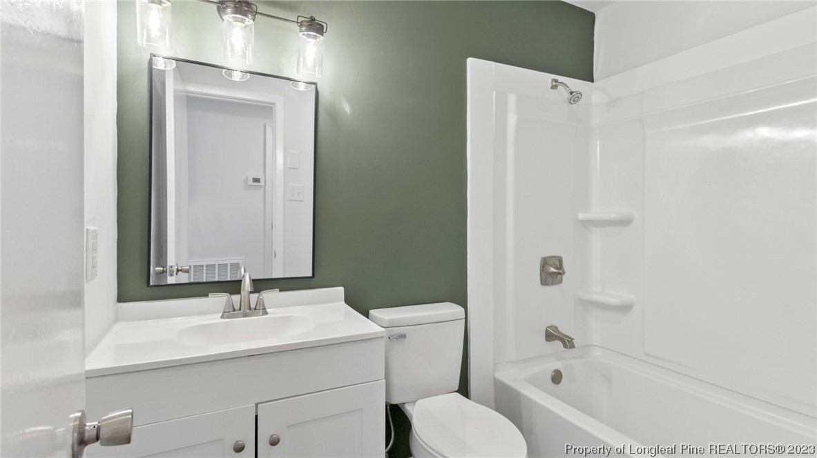5867 Columbine Road Fayetteville, NC 28306 - Photo 19 of 26 a bathroom with a sink toilet and shower