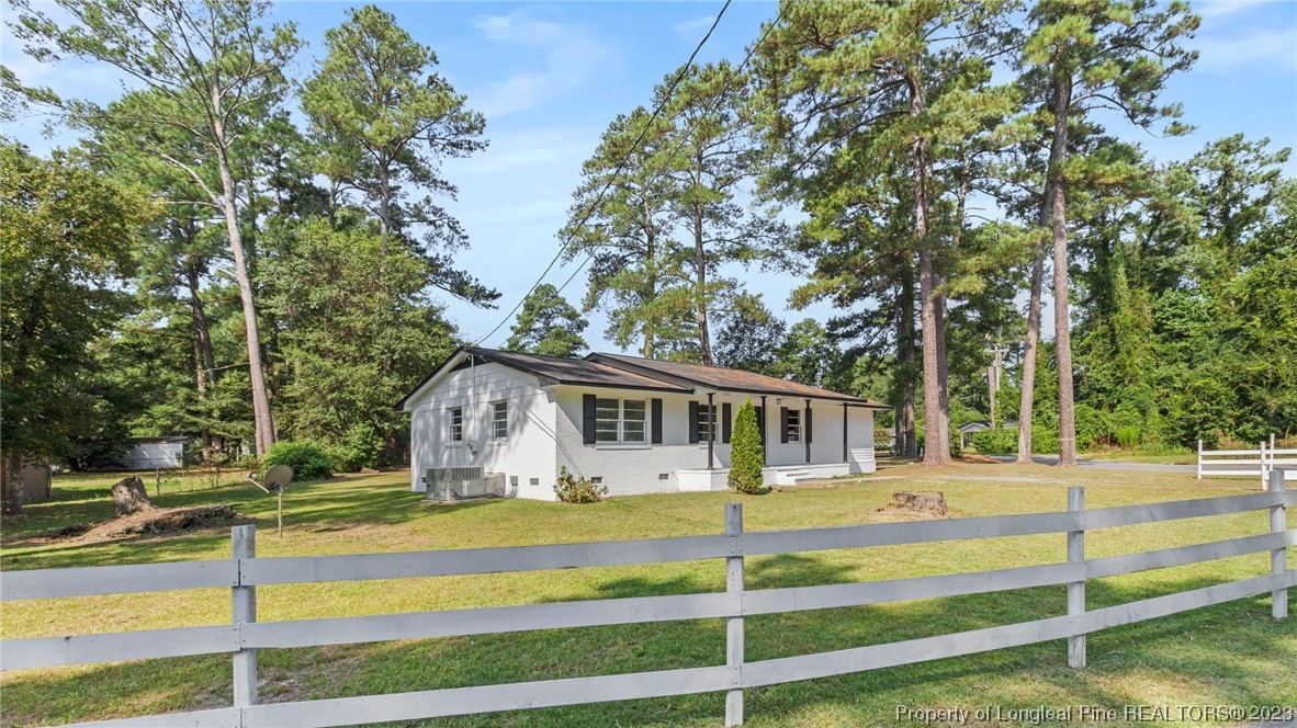5867 Columbine Road Fayetteville, NC 28306 - Photo 2 of 26 a view of a house with backyard and tree