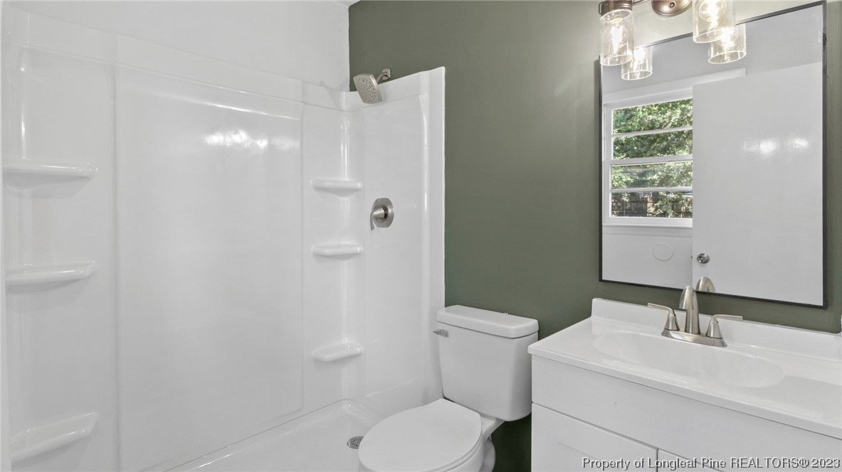 5867 Columbine Road Fayetteville, NC 28306 - Photo 23 of 26 a bathroom with a sink toilet and shower