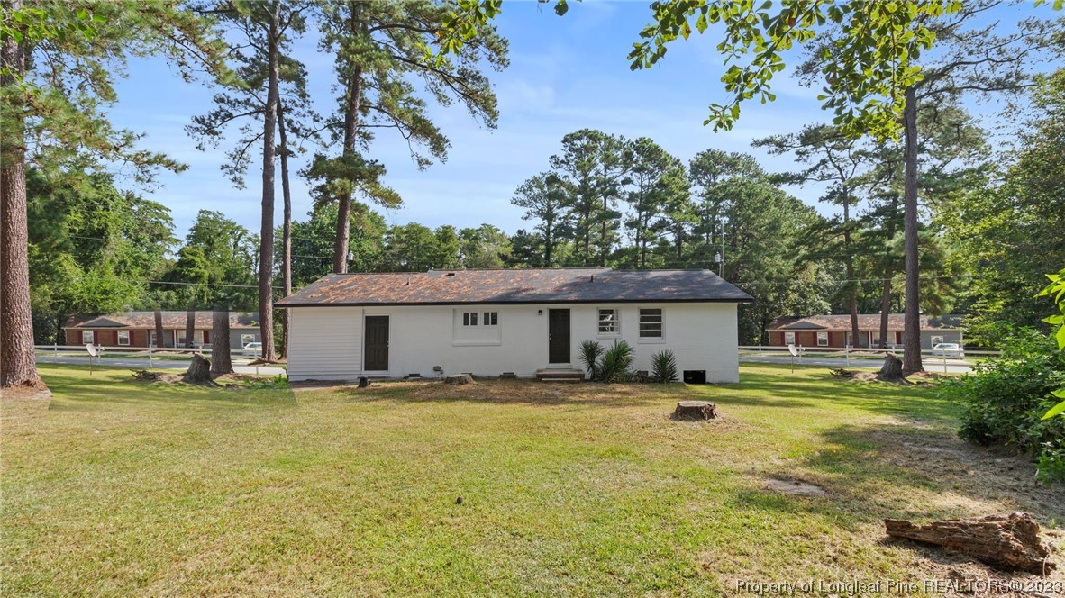 5867 Columbine Road Fayetteville, NC 28306 - Photo 24 of 26 a house view with a sitting space and wooden fence