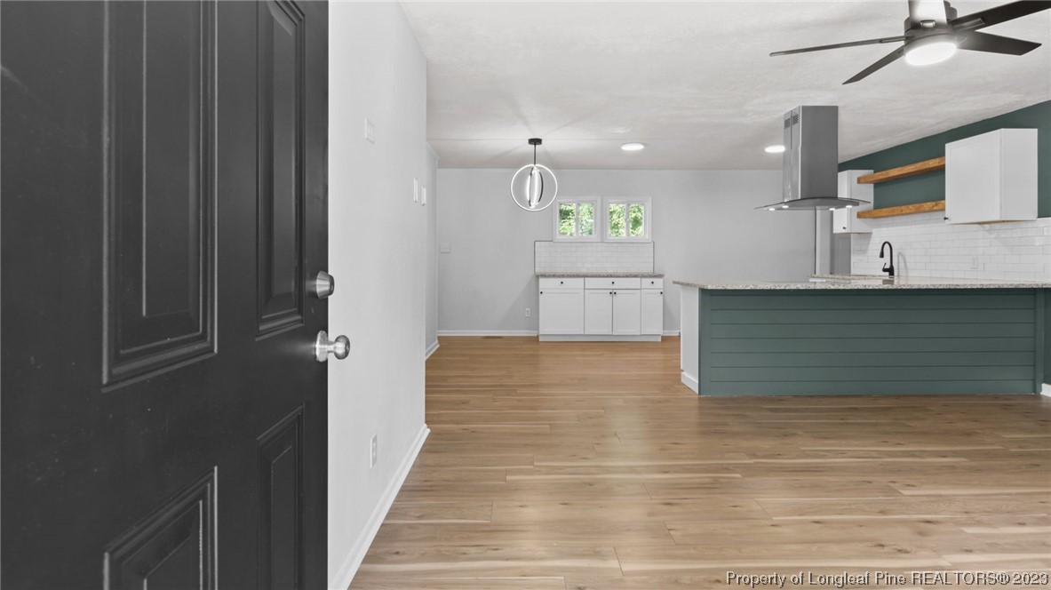 5867 Columbine Road Fayetteville, NC 28306 - Photo 3 of 26 a view of a kitchen with kitchen island microwave and stove